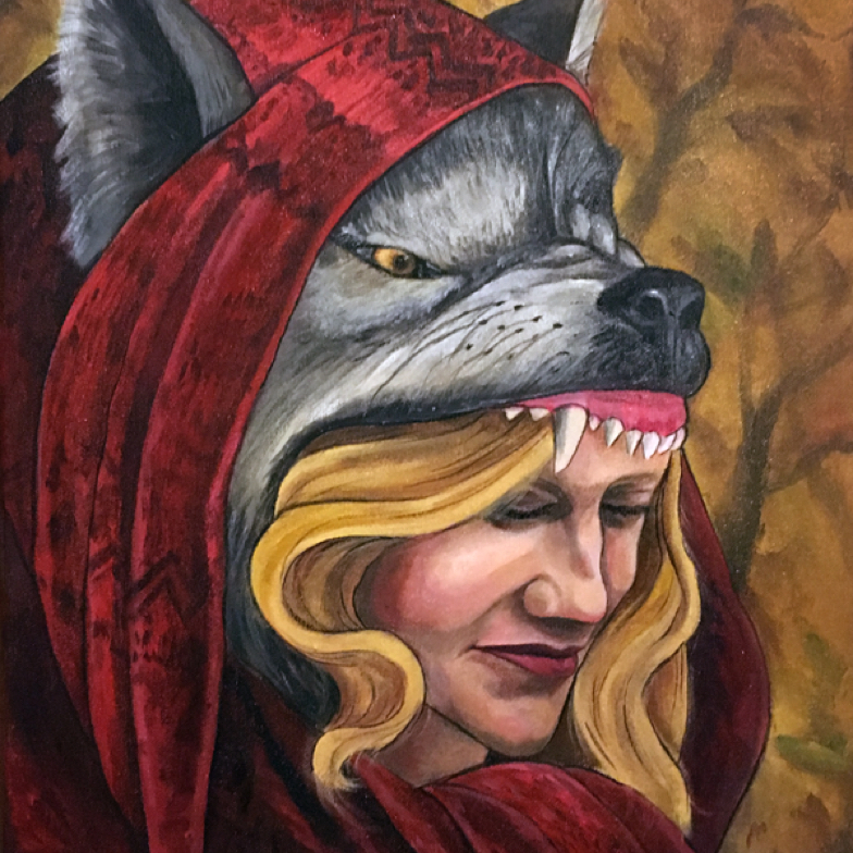 portrait of a young woman wearing a wolfs head and red scarf against an autumn forest backdrop